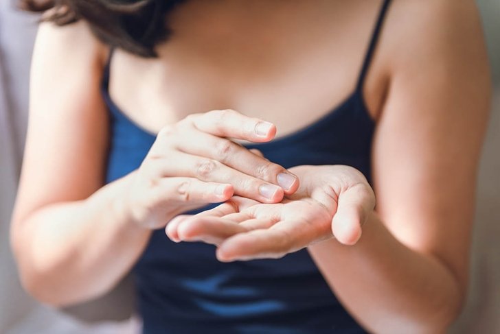 Beauty Body Skin Care and Cosmetic Apply Concept, Close-Up of Woman Hands is Applying Moisturizing Serum for Healthy Skin. Beautiful Woman is Using Moisturizer Aging Serum Treatment on Her Hands.