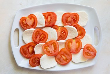 tomatoes and mozzarella cheese on a platter
