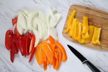 Slice onions and bell peppers