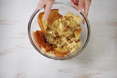 Crumbling yellow cake in a bowl with a fork