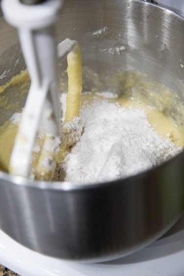 Stand mixer with butter, sugar, eggs, and flour