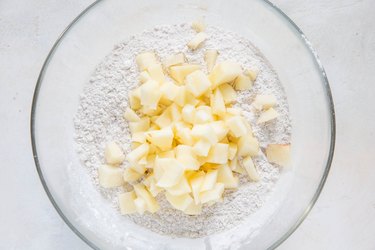 Chopped apple and flour in a bowl
