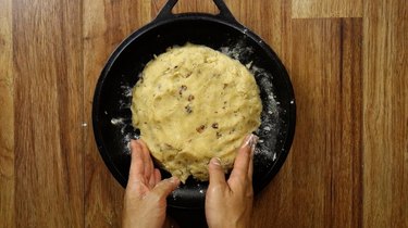 Shaping low carb gluten free maple pecan scone dough into a round, 7” in diameter.