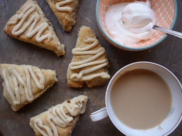 Gluten free low carb maple pecan scones with a cup of tea and whipped cream