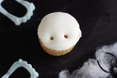Two holes poked into cupcake