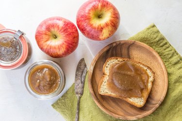 toast with apple butter and jars of apple butter