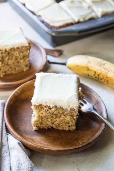 Two slices of banana cake on plates