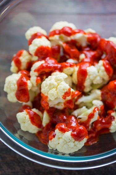 In a large bowl combine the cauliflower bites and buffalo sauce.