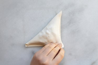 Fold the pastry to form a triangle.